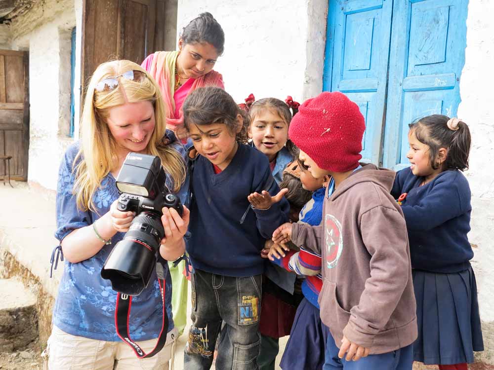 Team photographer and Rotarian, Charlotte Gale (Charlotte Gale Photography) shows primary school children some of the photos she has just taken of them