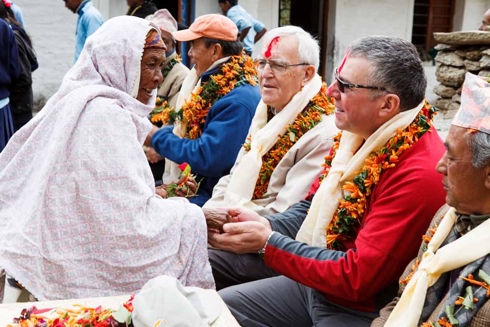 Rotarians John Ogbourne and Andy Morrison (Andisa IT) receive a traditional greeting from a villager at Shree Gaun Pharka LSS
