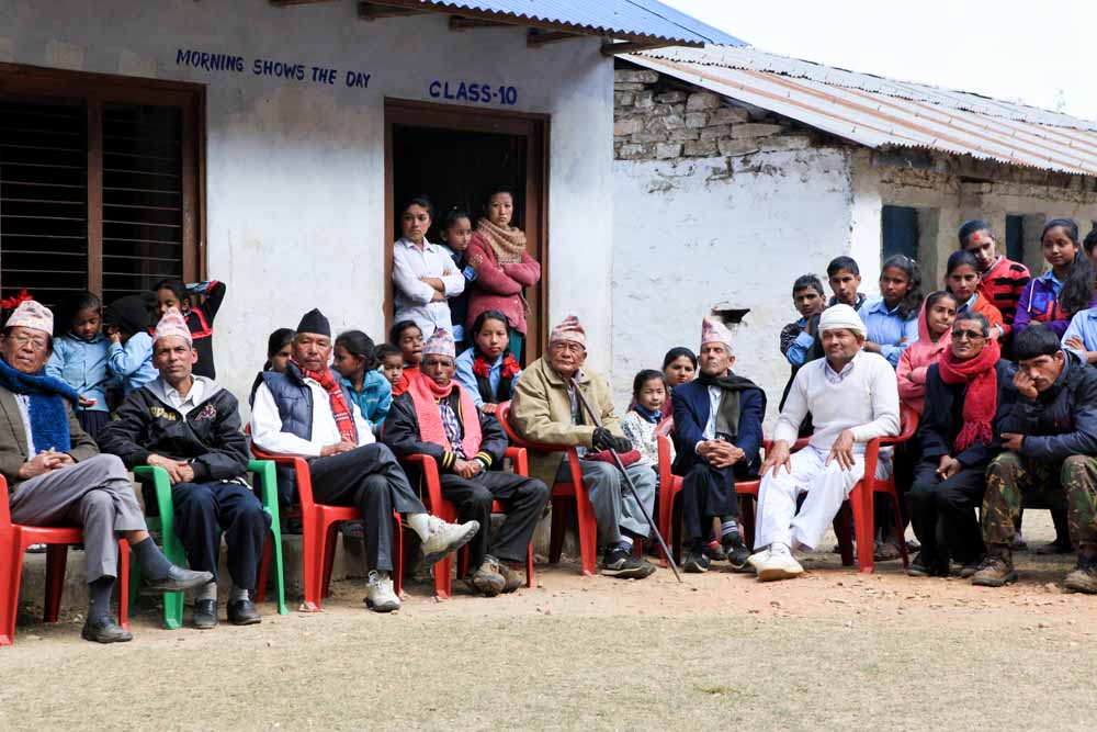 Rapakot villagers listen to project team members talk about the importance of literacy