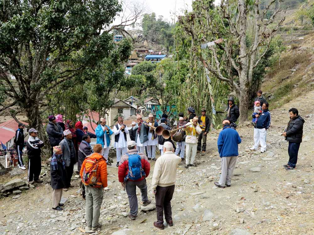 The project team receive a traditional welcome from villagers