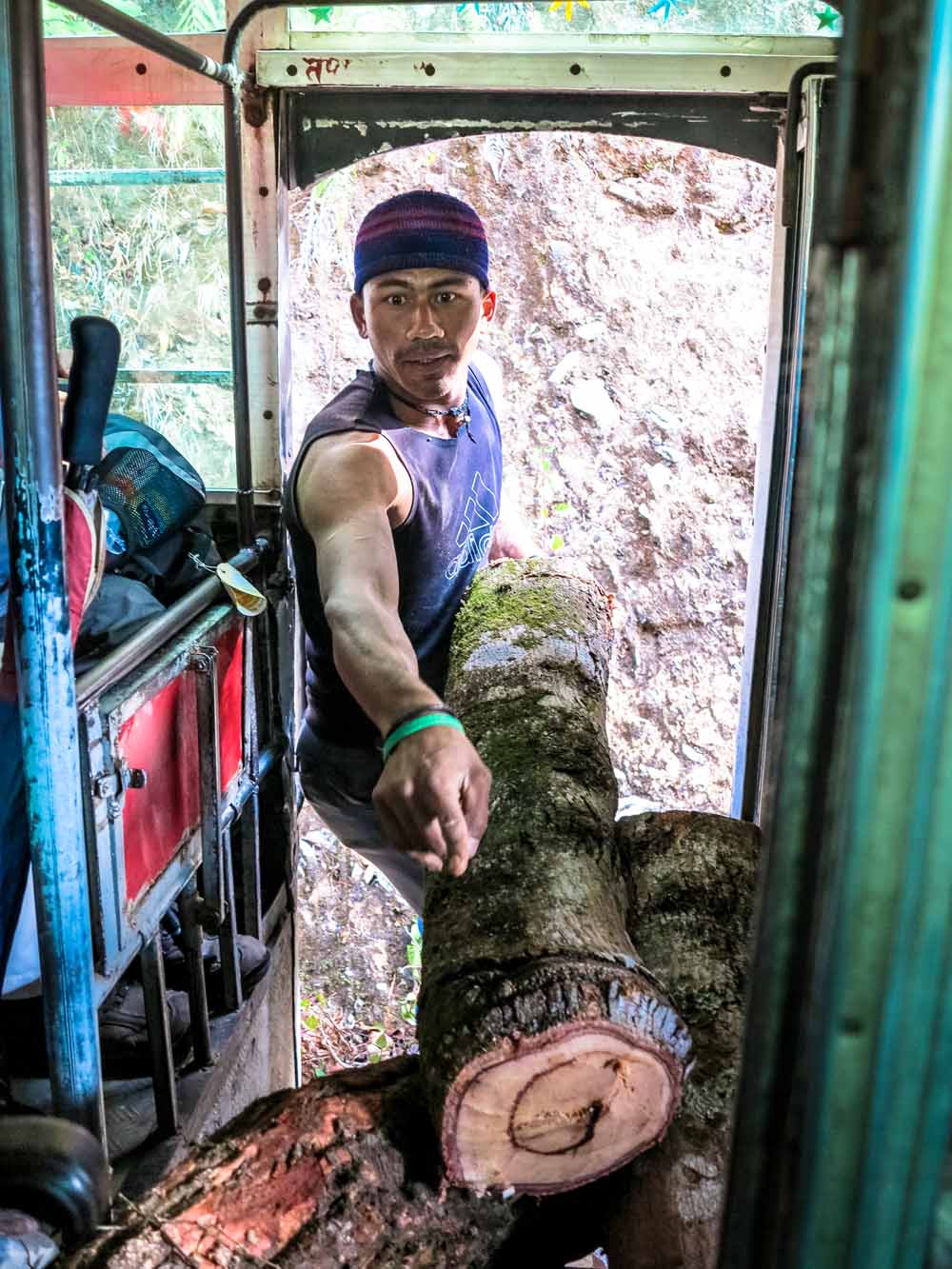 Local man loads logs onto the bus en-route to Daraun village