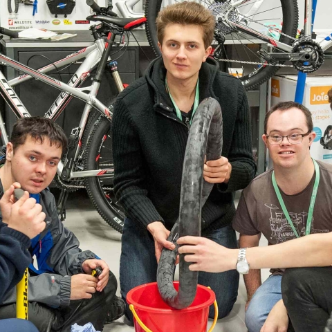 From left to right – Students Jake Vicars, Alex Lofthouse, Alex Guadagnino and Jacob Brown from Henshaws learn how to fix a puncture during a bike workshop with Adam Jones, Assistant Manager at Halfords on Knaresborough Road