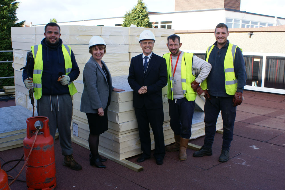 Headteacher Helen Woodcock and Director of Finance Joe Joyce with contractors working on site at Rossett School.