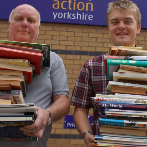Book It! Disability Action Yorkshire apprentice James Parker (right) and learning support assistant Ian Sheard prepare for Saturday’s Big Book Sale
