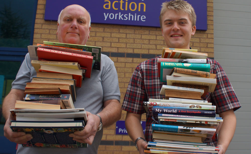 Book It! Disability Action Yorkshire apprentice James Parker (right) and learning support assistant Ian Sheard prepare for Saturday’s Big Book Sale
