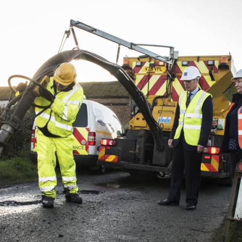 County Councillor Don Mackenzie and Highways Customer Communication Officer Deborah Flowers see a jet patcher in action