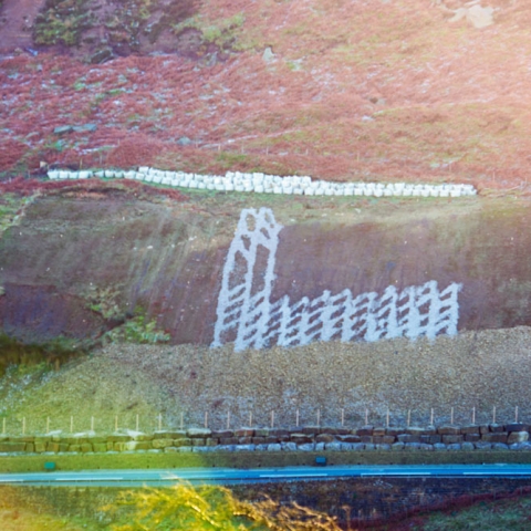 The slope above the A59 at Kex Gill with the road in the foreground. The area of the slope that is of most concern is on the left of the photo