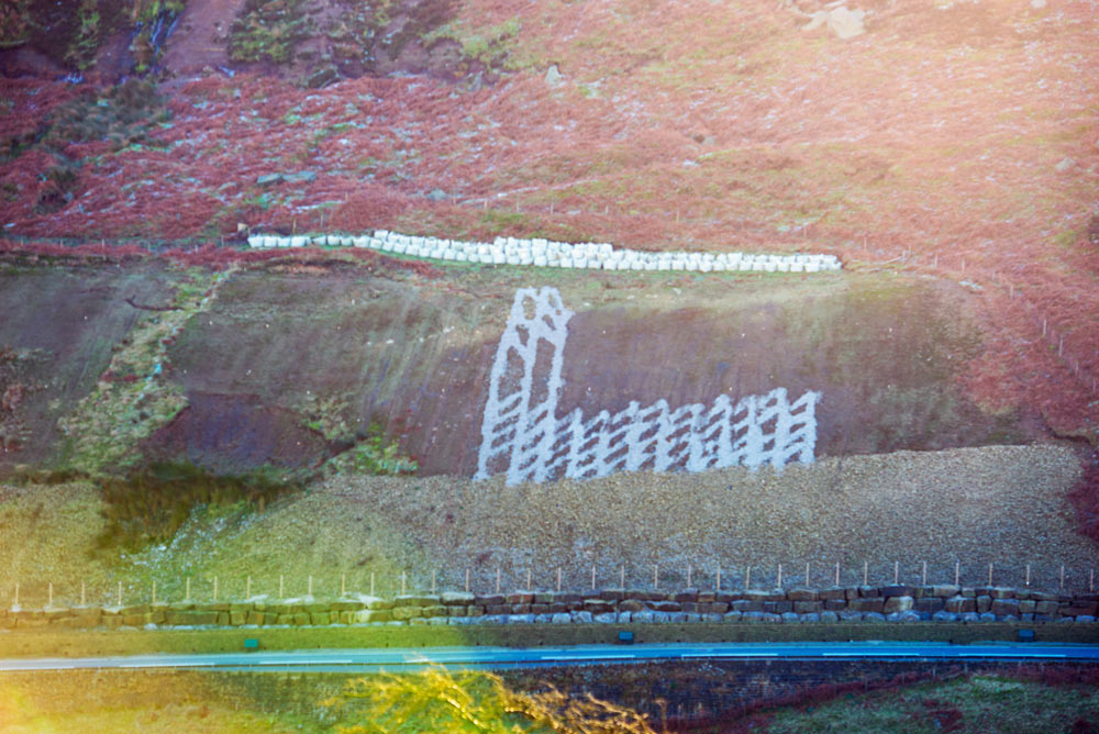 The slope above the A59 at Kex Gill with the road in the foreground. The area of the slope that is of most concern is on the left of the photo