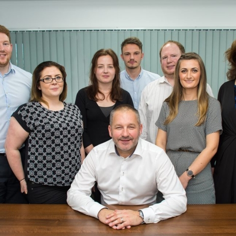 Fuelling success: Paul Parkinson (seated) with new Synergy Automotive team members