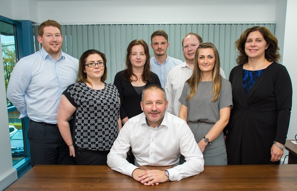 Fuelling success: Paul Parkinson (seated) with new Synergy Automotive team members