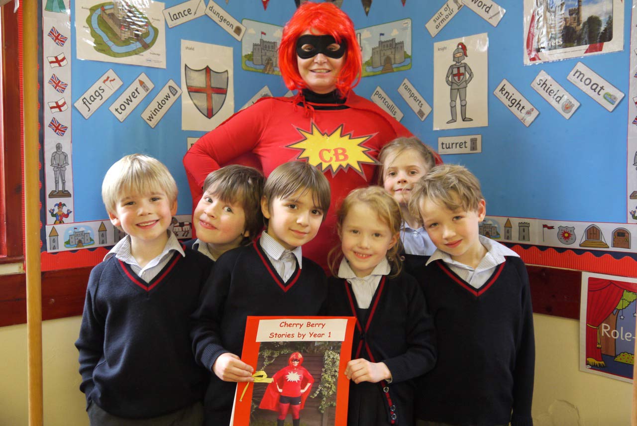 Mrs Nicola Shillam, AKA Superhero Cherry Berry and Year 1 pupils at Belmont Grosvenor School