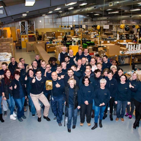 EnviroVent staff at the Harrogate factory with the one millionth golden fan they have produced to mark this special occasion