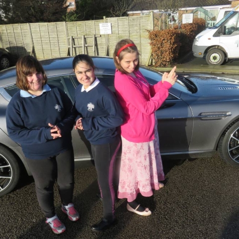 Pupils from Forest School strike a pose with the Aston Martin