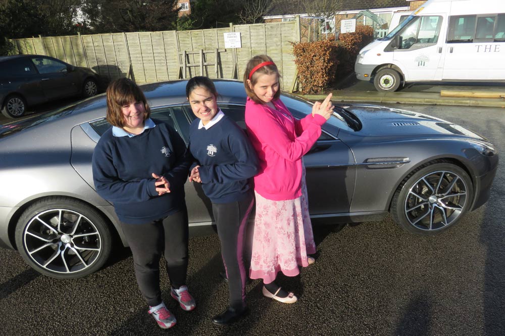 Pupils from Forest School strike a pose with the Aston Martin