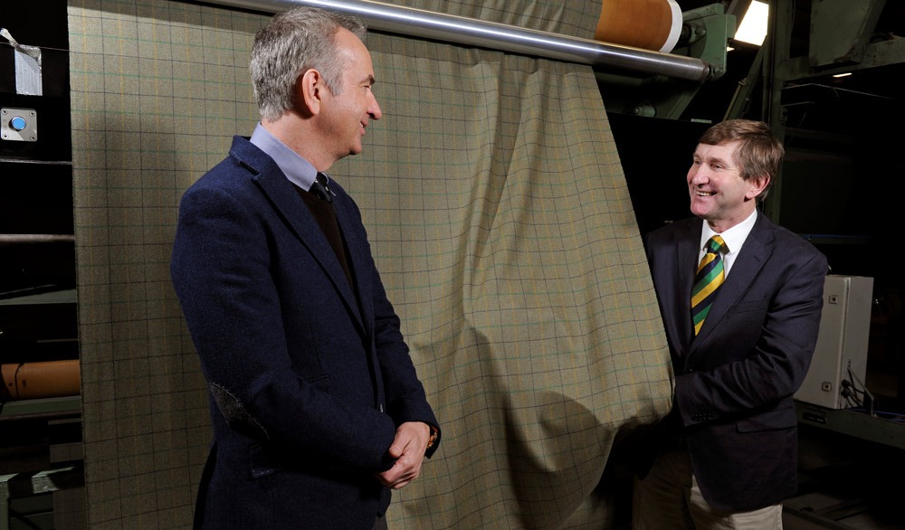 Charles Mills, Show Director of the Great Yorkshire Show and John Walsh, Managing Director of Abraham Moon & Sons watching the specially commissioned Yorkshire tweed coming off the loom at Moon’s Guis