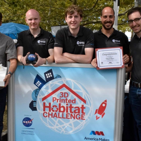 Leo Teeney (centre) and the team from ESA winning their award from NASA for LavaHive