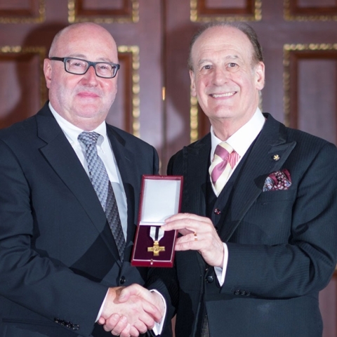 Peter McCormick OBE, left, receives the Order of Mercy from Lord Lingfield
