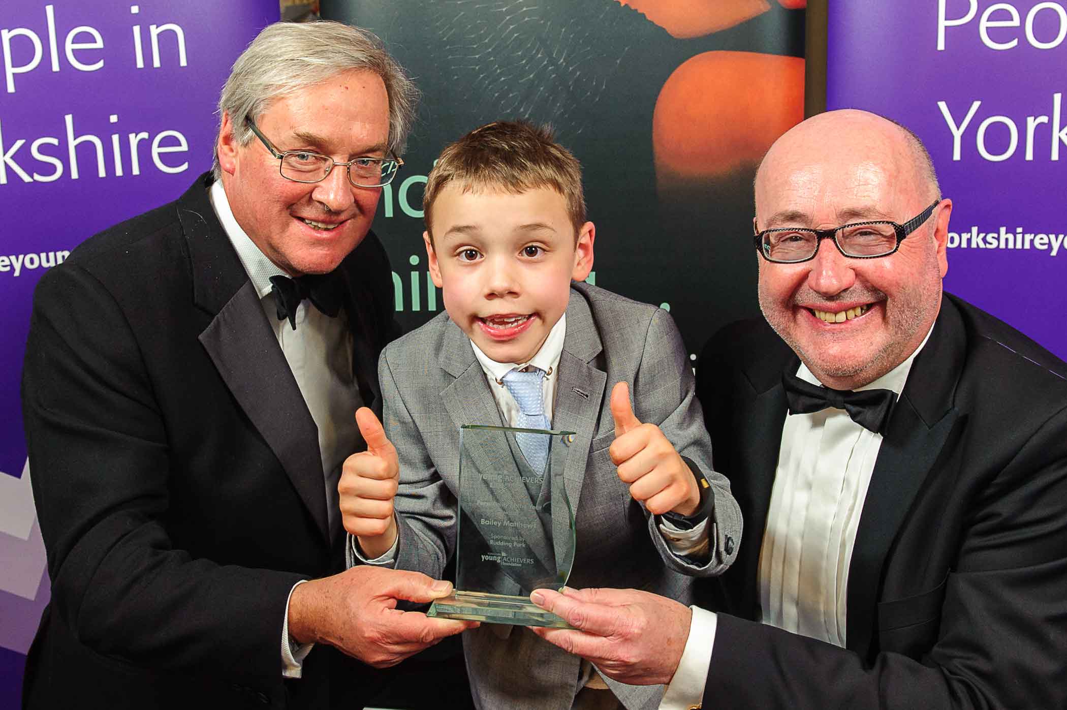 The 2015 Personality of the Year, Bailey Matthews, receives his Award from sponsor Simon Mackaness, of Rudding Park, and Chairman Peter McCormick OBE