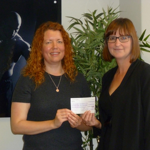 Megan Itson receives the cheque from Sonia Jones