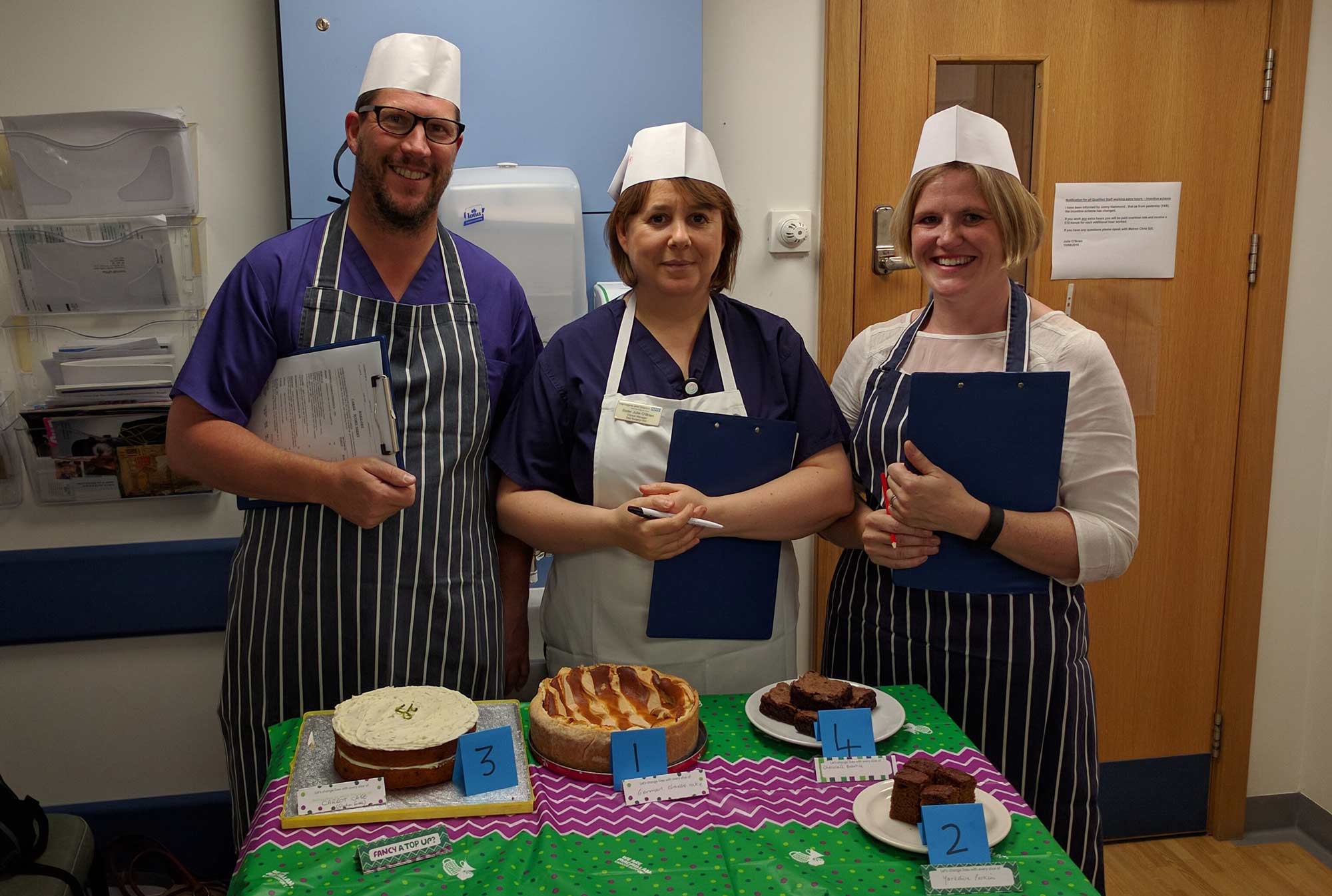 Sampling the delights - Staff play the part of Bake Off judges in best cake competition