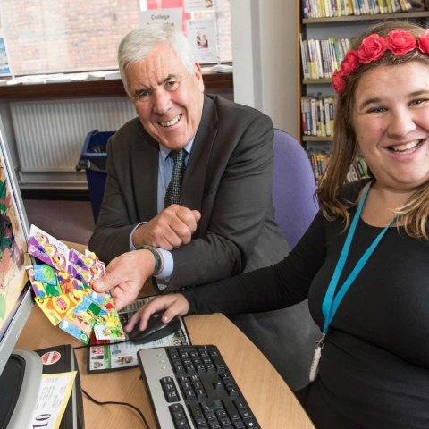 Emy Spinks with County Councillor Chris Metcalfe and the new library cards