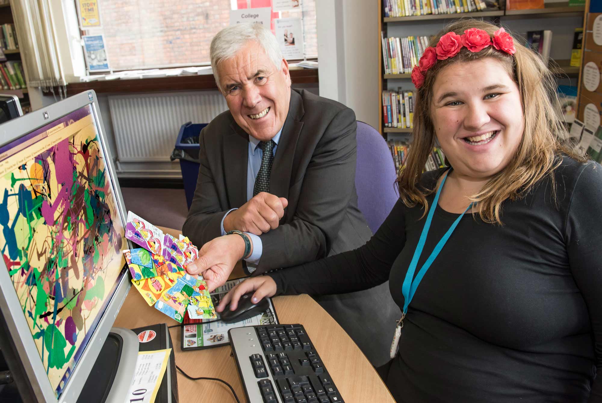 Emy Spinks with County Councillor Chris Metcalfe and the new library cards