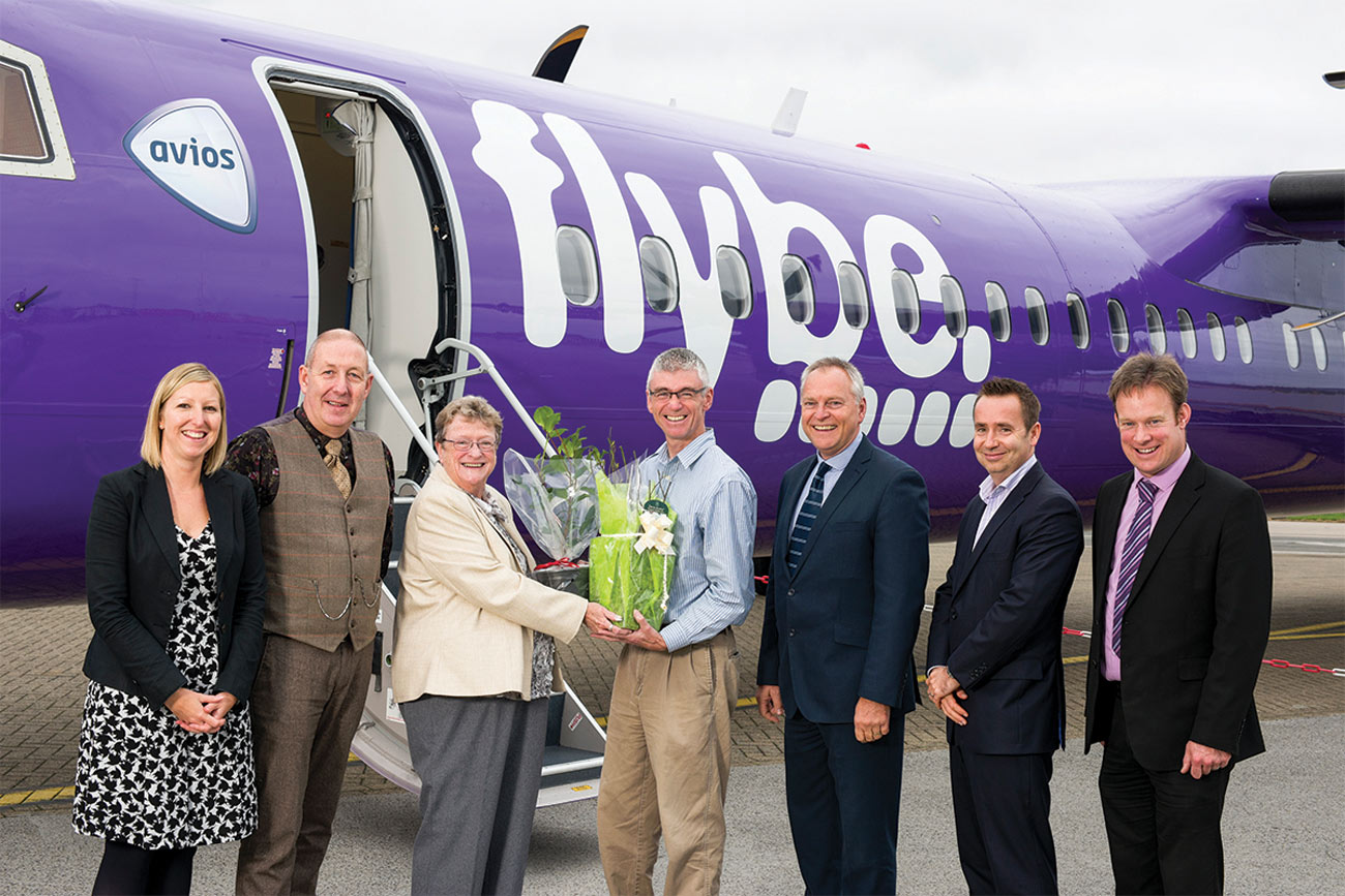 Judith Donovan swaps plants with Gordon Seabright of the Eden Project on the apron at Cornwall Airport Newquay. With (L-R) Kayley Worsley, Nigel Eaton, Paul Willoughby, Al Titterington and Adam Paynter
