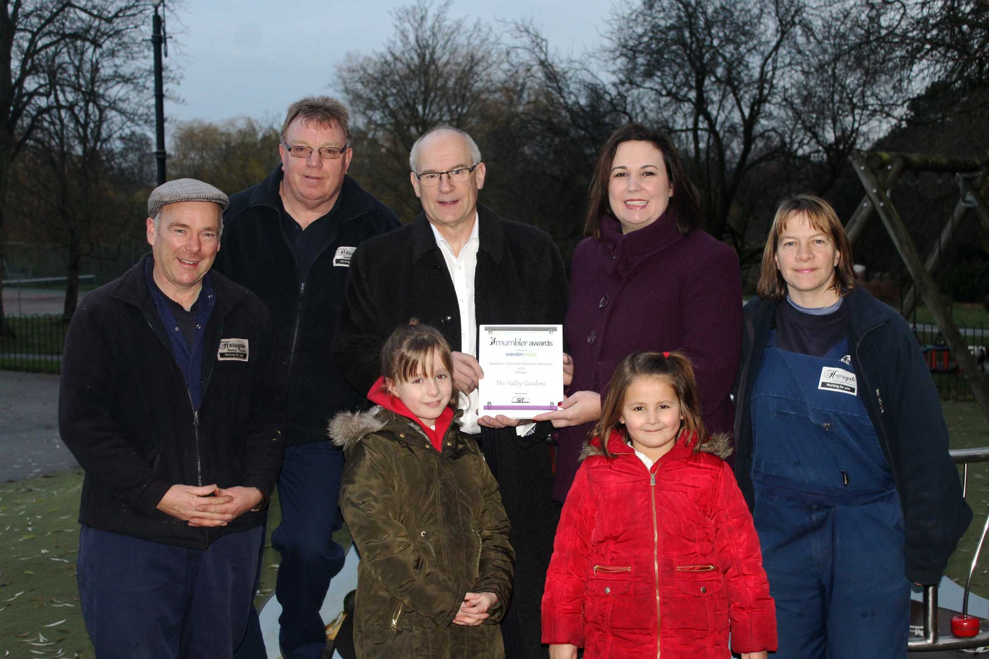 Harrogate MUMbler’s Sally Haslewood and daughters Tilly and Eva present the award won by Valley Gardens to (L-R) gardener Simon Collier, Senior Play Area Technician Tony Jackson, Head of Parks & Environmental Services Patrick Kilburn and gardener Paula Collier