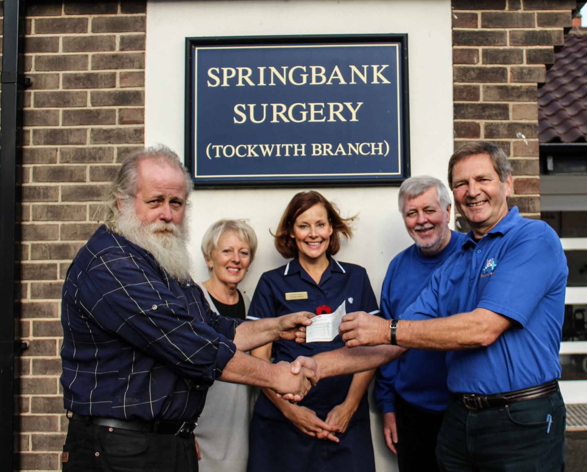 Arnold Warneken, chair of the Springbank health patient group committee, committee member Jane Bannan, and Tockwith surgery nurse Christine Edmond receive a cheque for £1,000 from TADAS treasurer Malcolm Barrett and co-chairman Sam Blacker