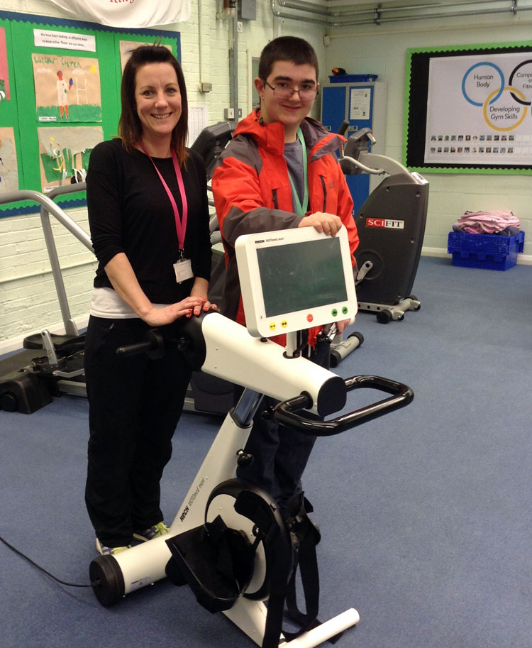 Vicky Little with student Tom Oates and the new MOTOmed movement trainer he has helped to buy