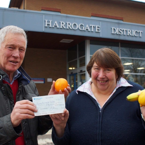 Kerching! Bill Baker from Otley Chevin Rotary Club presents a cheque for £250 to Harrogate Hospital Radio fundraiser Ellie Jackson