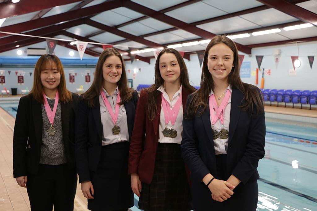 The Senior Girls’ Swimming Squad proudly showing their medals
