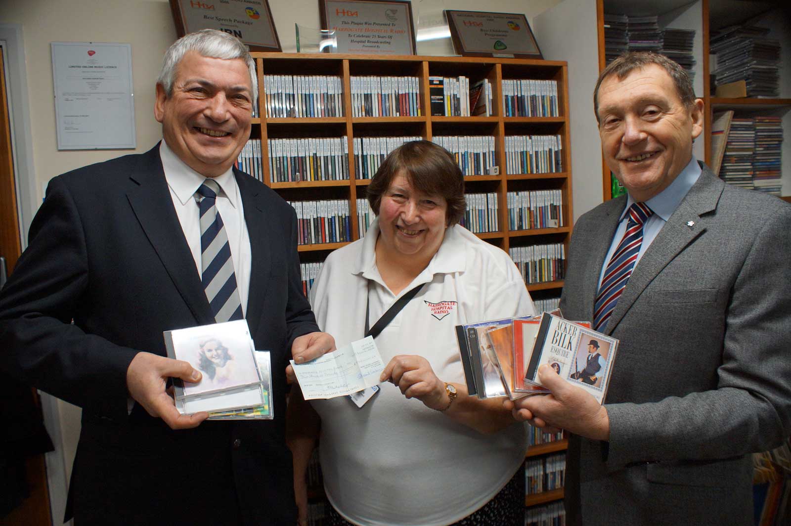 Rack & Roll! Freemasons John Birkenshaw (left) and Mike Baxter from Harrogate and Claro Lodge, present Harrogate Hospital Radio fund-raising officer Ellie Jackson with a £500 cheque for new CD storage units