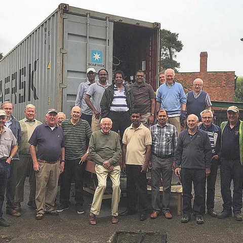 PhysioNet volunteers with a 40 foot container ready for shipping to SrI Lanka in July