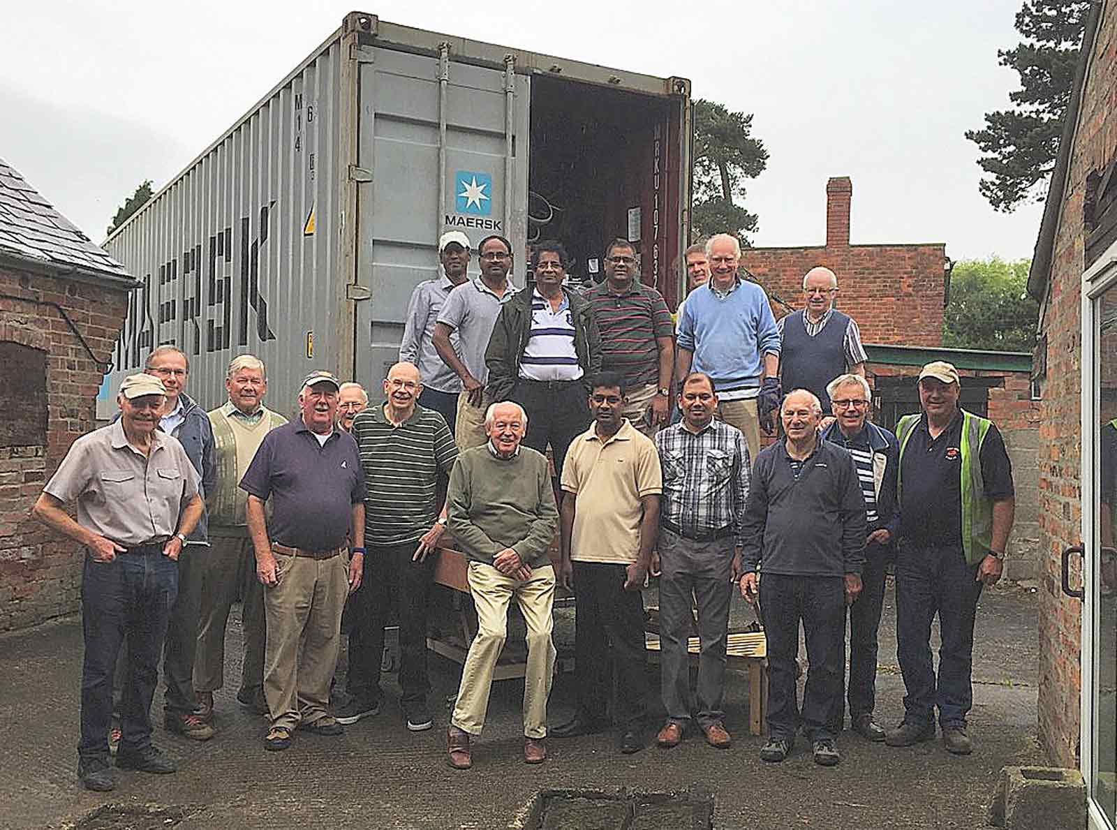 PhysioNet volunteers with a 40 foot container ready for shipping to SrI Lanka in July