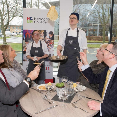 Student Chef, Jake Taylor, serves the pancakes