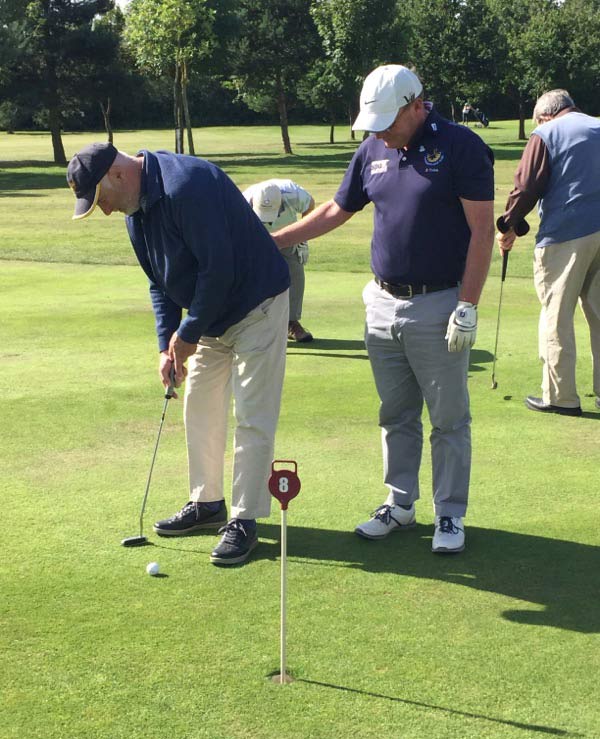 Anthony teaching Norman his new golfing skills