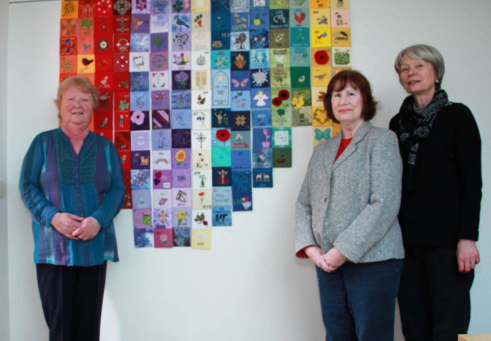 Textile artist Maureen Fackrell of Knaresborough, Washburn Stitcher Liz Carnell of Harrogate and project leader Sally Robinson of Fewston, with the Fewston Assemblage Project panel