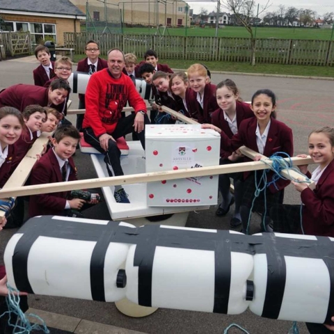Water-borne Comedy Challenge. Ashville Junior School teacher Ian Dimmick is given a helping hand putting his bath raft together by his class