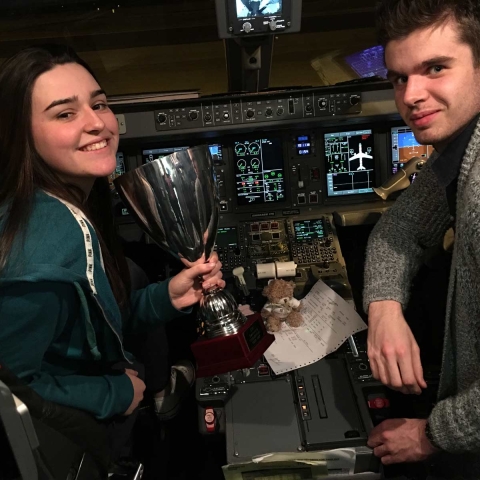 Flying Finish! Ashville Swimming captains James Sadler and Rosie Rudolph in the cockpit before flying home with the European Trophy
