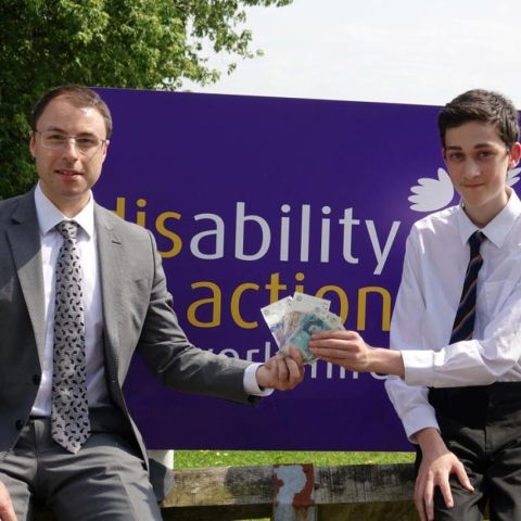 St Aidan’s Year 10 pupil Aidan Wheeler presents the proceeds of the cake bake to Disability Action Yorkshire’s Operation Manager David Ashton Jones