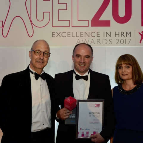 Phillip Marshall (centre), Director of Workforce and Organisational Development at Harrogate and District NHS Foundation Trust, receiving his award