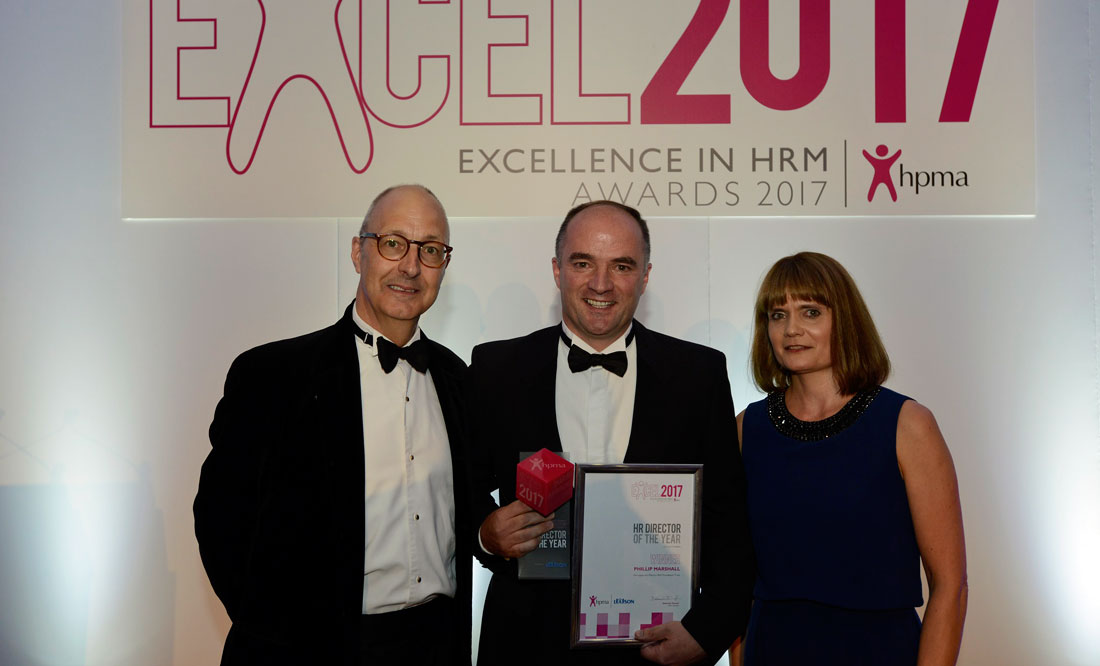 Phillip Marshall (centre), Director of Workforce and Organisational Development at Harrogate and District NHS Foundation Trust, receiving his award