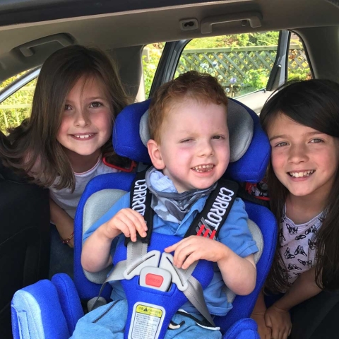 Felix in his new car seat with his big sisters, Kitty, left, and Amelie
