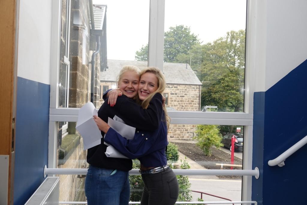 Claudia Pearson (left) hugs classmate Isabel Paxton