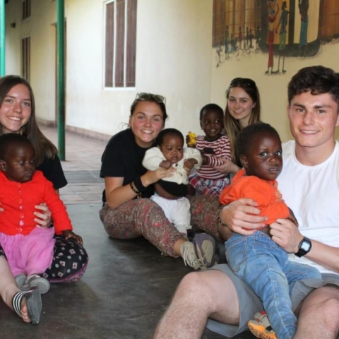 Isabel Stonehouse, Rhianna Malyn, Ellie Dormer and Robbie Leventhal with children at the orphange