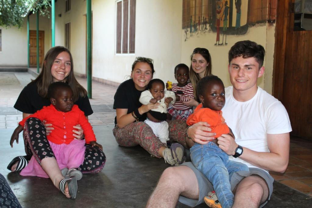 Isabel Stonehouse, Rhianna Malyn, Ellie Dormer and Robbie Leventhal with children at the orphange