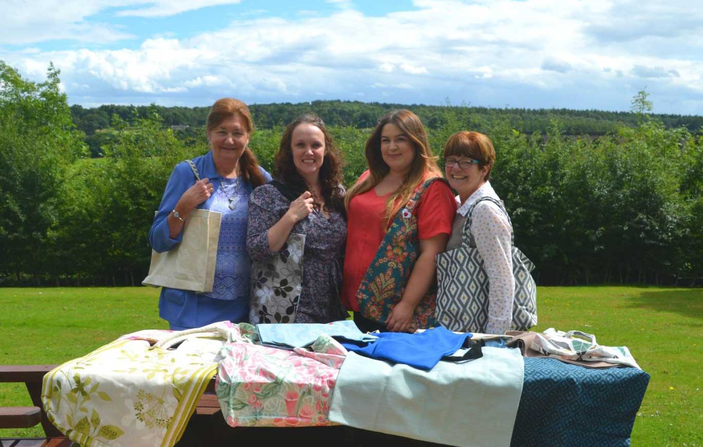 The Cone Exchange and Saint Michael’s team proudly showing off their bags. From left to right: Christine Smith, Cone Exchange Volunteer; Sarah Wells, Community Manager Bettys & Taylors Group; Alex Thomas, Healthcare Assistant Manager Saint Michael’s Hospice; Sue Snow, Cone Exchange Volunteer