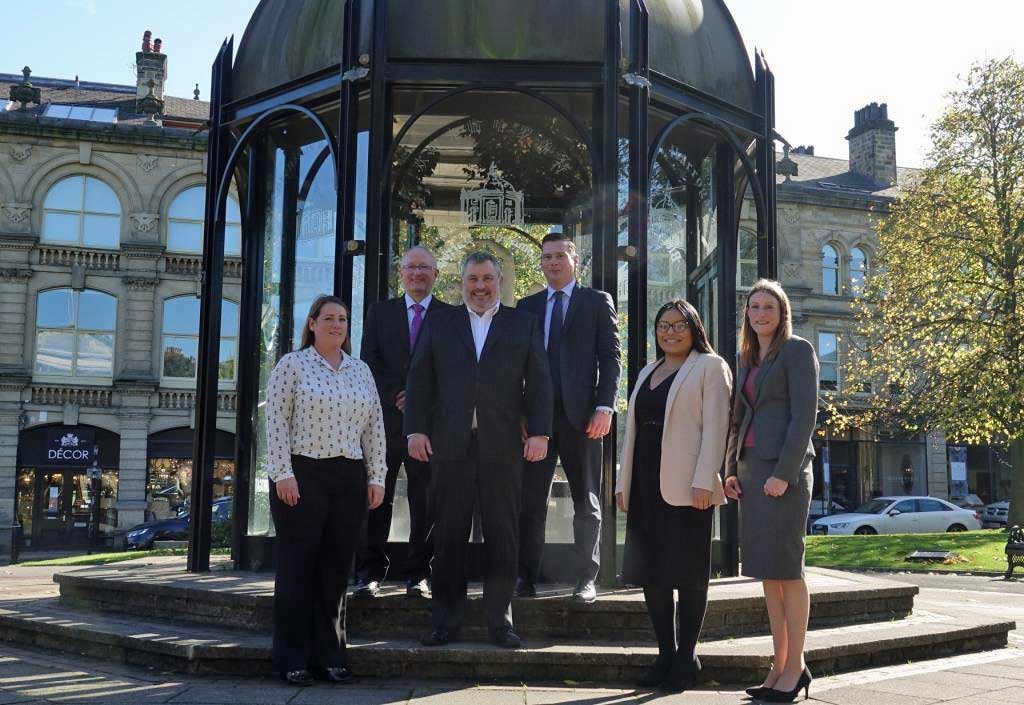Expansion . . . Milners’ managing partner Simon Bass, centre, pictured with a Harrogate team strengthened by the appointment of conveyancing expert John Robson, second left