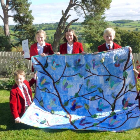 the winning quilt, Free As a Bird, with Belmont Grosvenor School pupils, from left to right, Tom Haggas, Isabelle Fryer, Annabelle Barlow, Jack Shillam and Emily Dennis